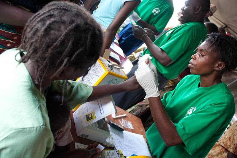 A patient gets tested for malaria. PATH/Gena Morgan